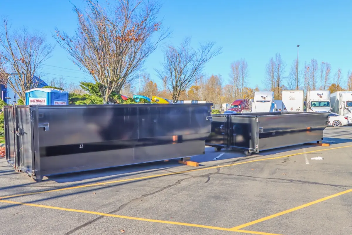 Professional dumpster rental service with roll-off container on residential driveway in Weirton